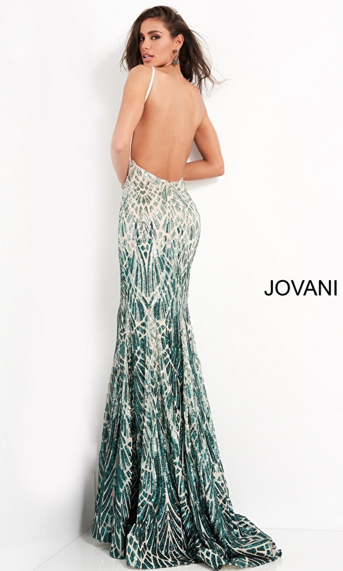 A woman stands against a white background in the Jovani 06450 Sequin-Print Long Prom Dress, a backless, floor-length green and white mermaid gown with thin straps.